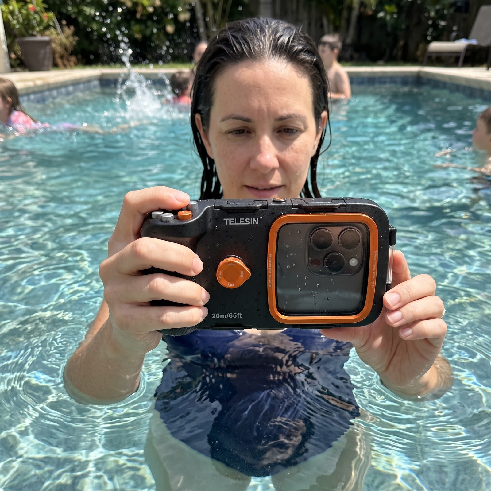Woman using Tideglass at the edge of a swimming pool