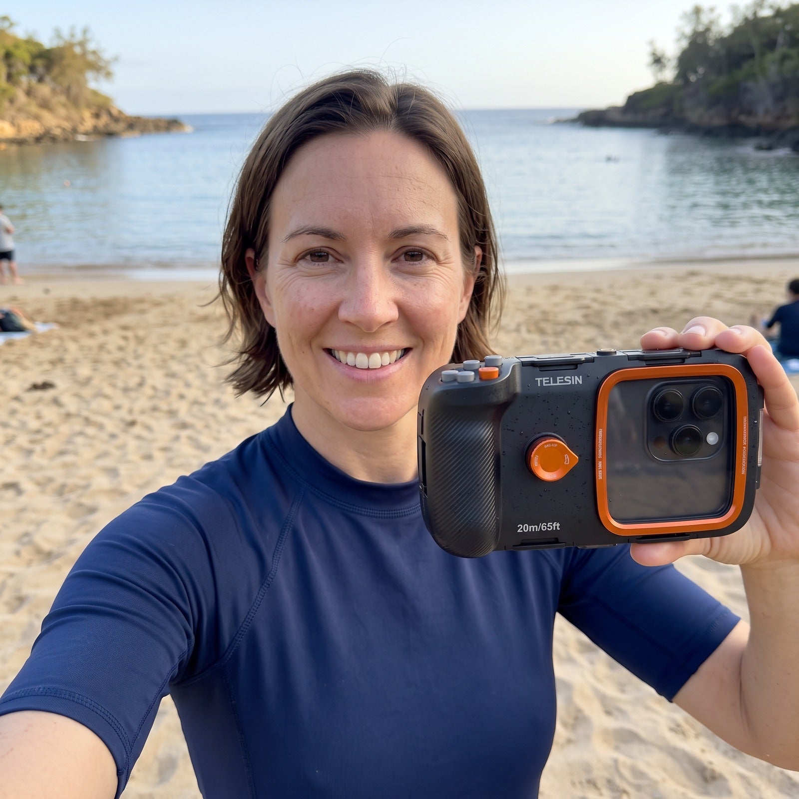 Woman taking a coastal selfie with the Tideglass housing